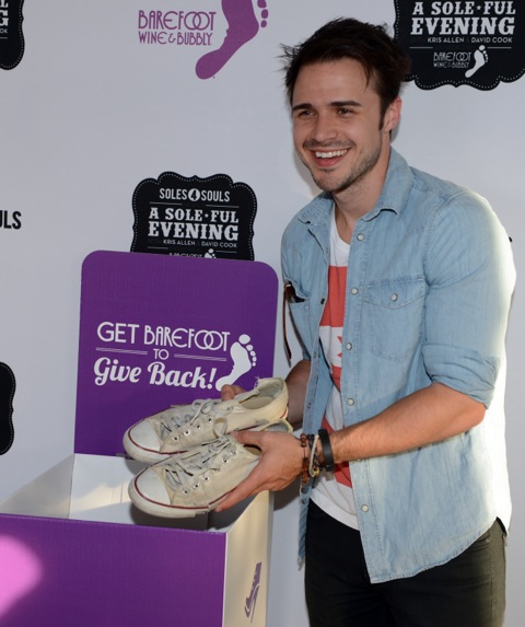 Kris Allen donates a pair of shoes for Soles4Souls at the Barefoot Wine & Bubbly sponsored chairty concert