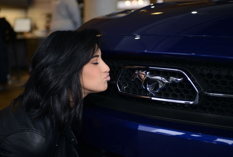 Jena Irene gives her Mustang a kiss